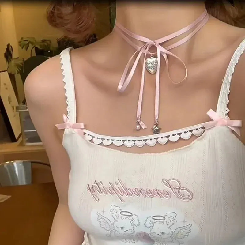 Close-up of a women's alloy necklace with a ribbed heart pendant on a clavicle-length chain.