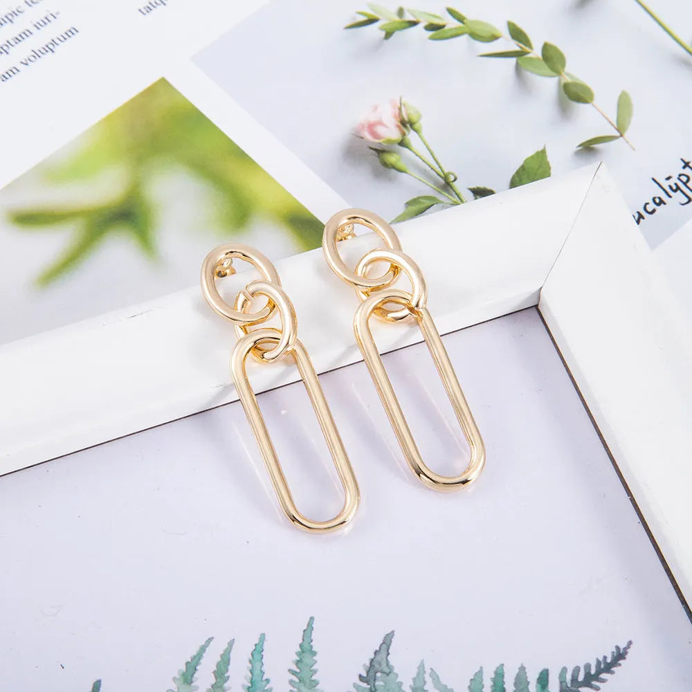 Sterling silver needle coloured geometric hoop earrings for women with ring and line design.