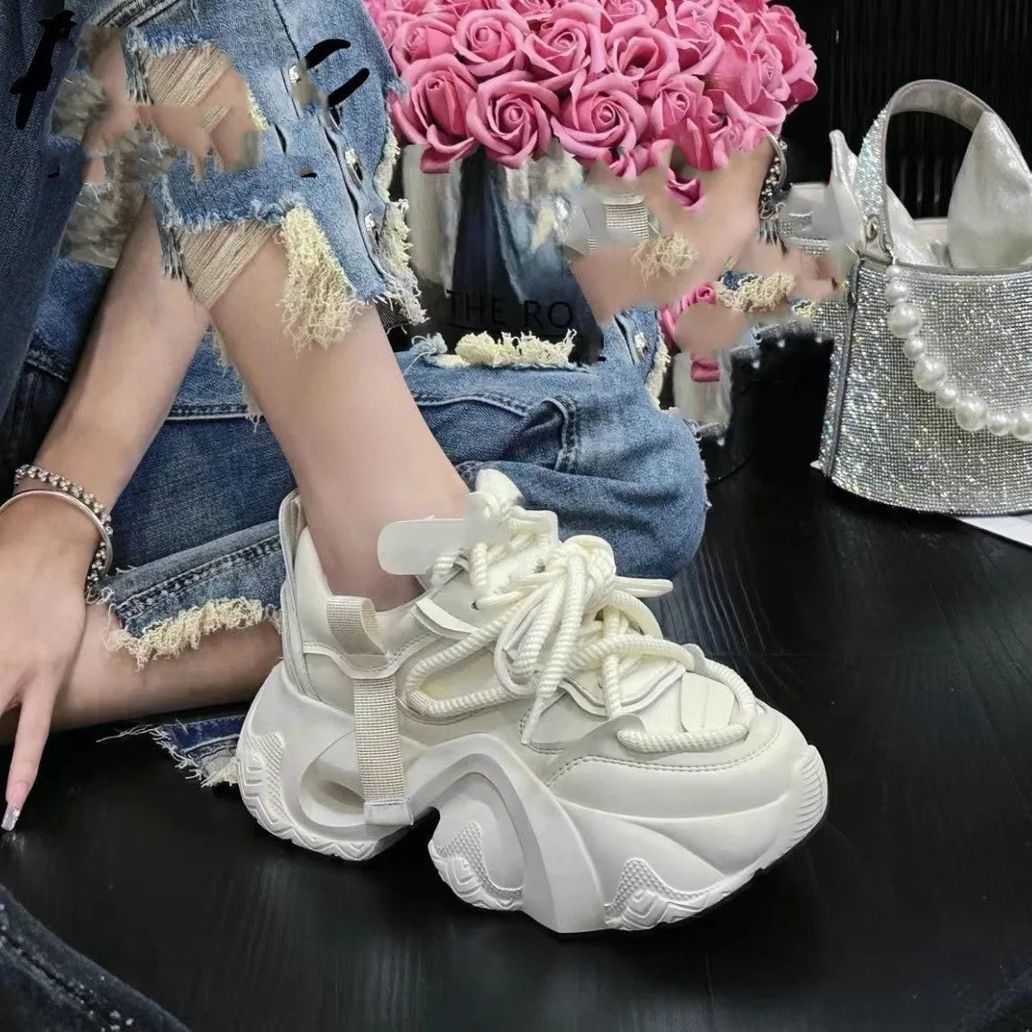 Women's creamy white platform sneakers with wedge heel, cross-strap detail, and lace-up front.