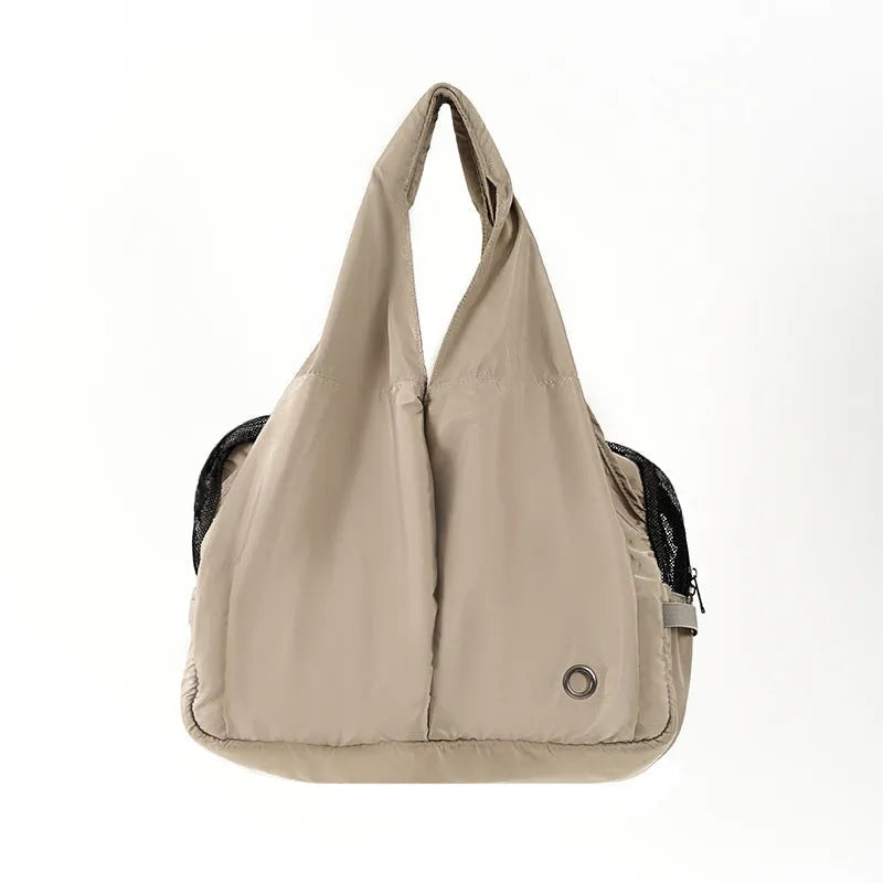 Apricot coloured cloth pet carrier handbag showing breathable fabric and portable design