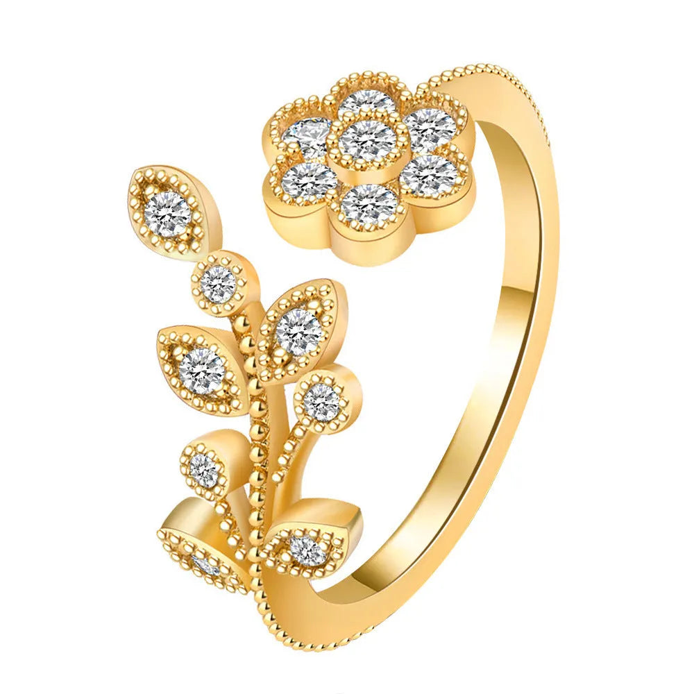 Women's open copper ring with diamond-treated floral and leaf design in gold colour.