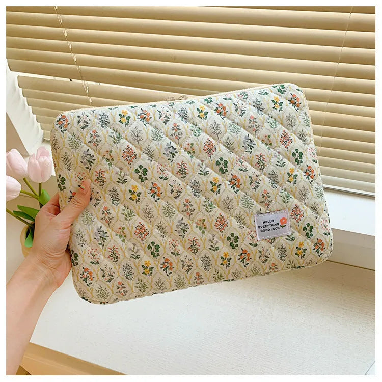 Floral print cloth laptop bag showing green flower pattern with storage compartments and anti-seismic protection
