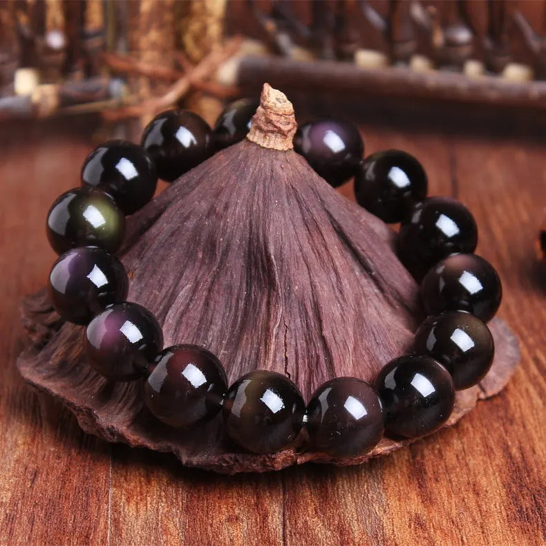 A polished crystal Pi Xiu bracelet with geometric beads on a white background.