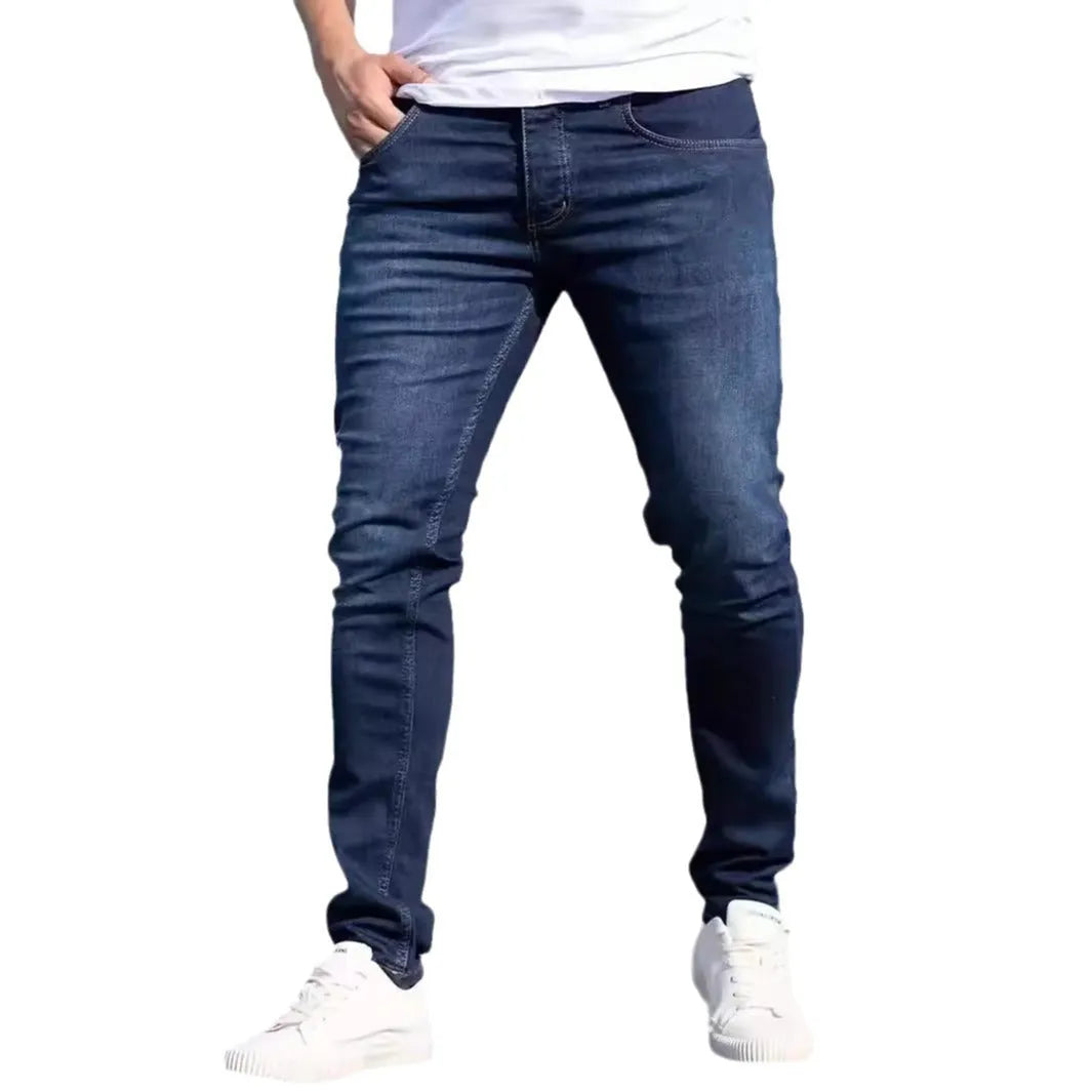 Men's dark blue slim fit casual jeans with skinny leg opening and mid waist