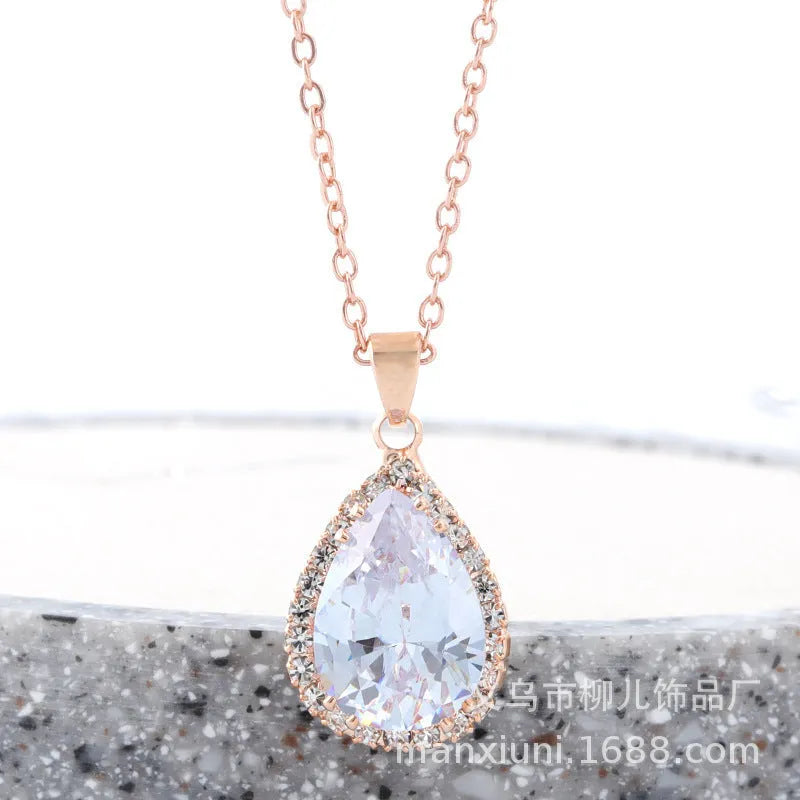 Pink water drop geometric necklace with rose gold electroplating and rhinestone detailing on alloy pendant
