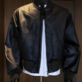 Men's black PU leather jacket with litchi grain texture, showing extended 100cm length and tight fit.