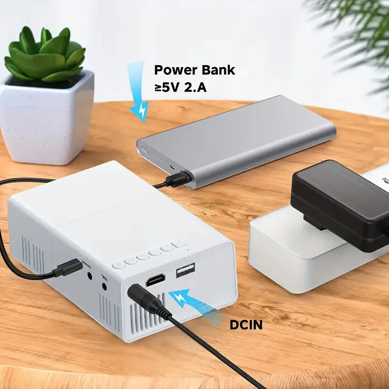 M100 Mini Home LED Projector in black or white, showing remote control and cables.