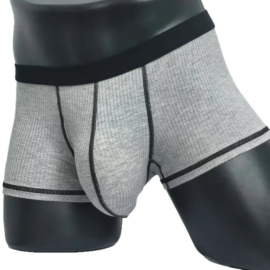 Solid-colour men's boxers in breathable fibre fabric on a size chart.