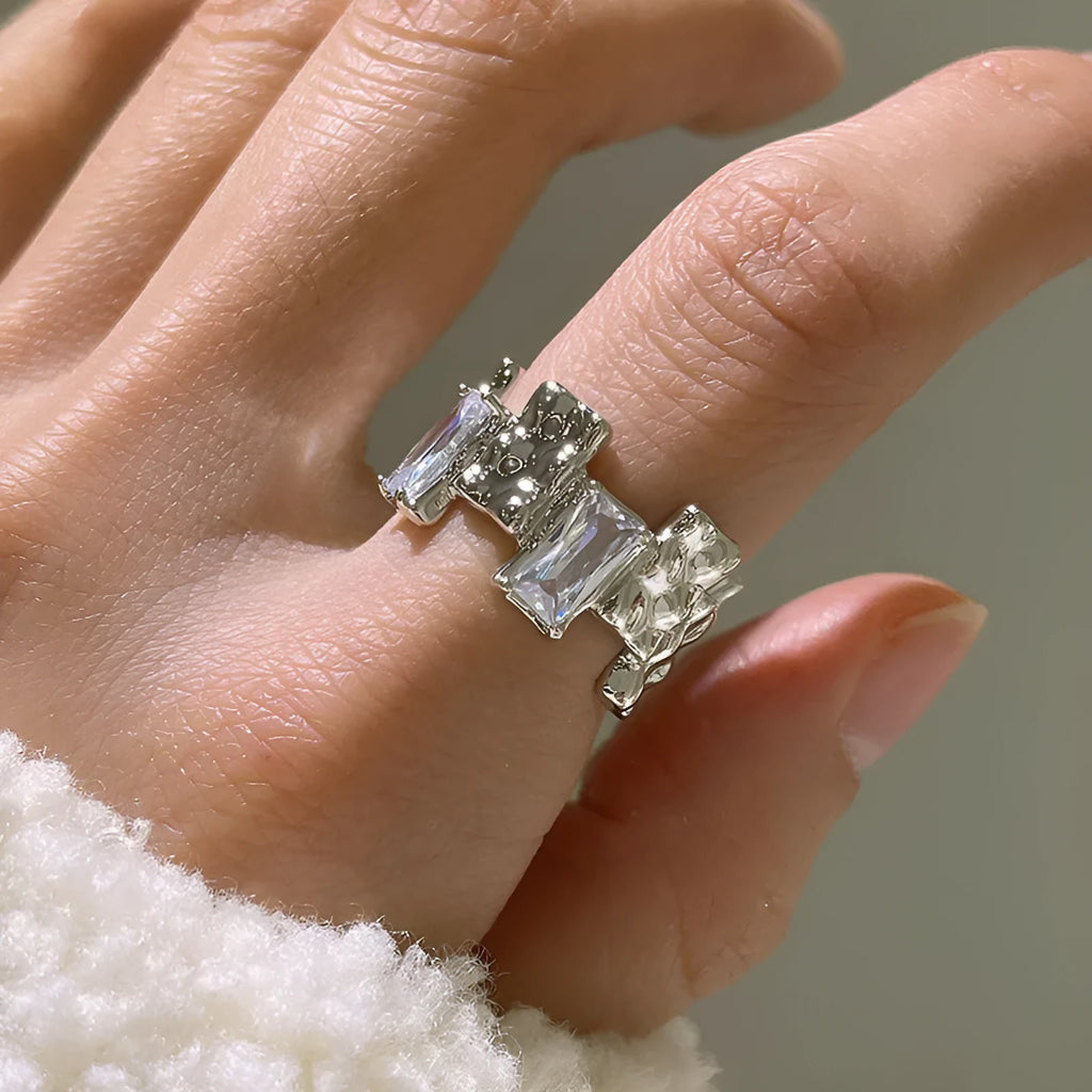 Silver geometric zircon cross ring with open centre and retro design