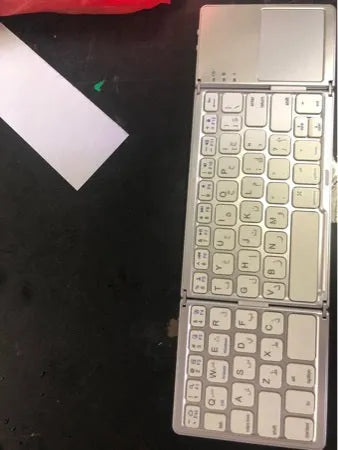 Black tri-fold folding Bluetooth keyboard with touchpad shown unfolded and folded