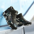 Green camouflage canvas women's trainers with rubber soles showing size range 35-42 EU