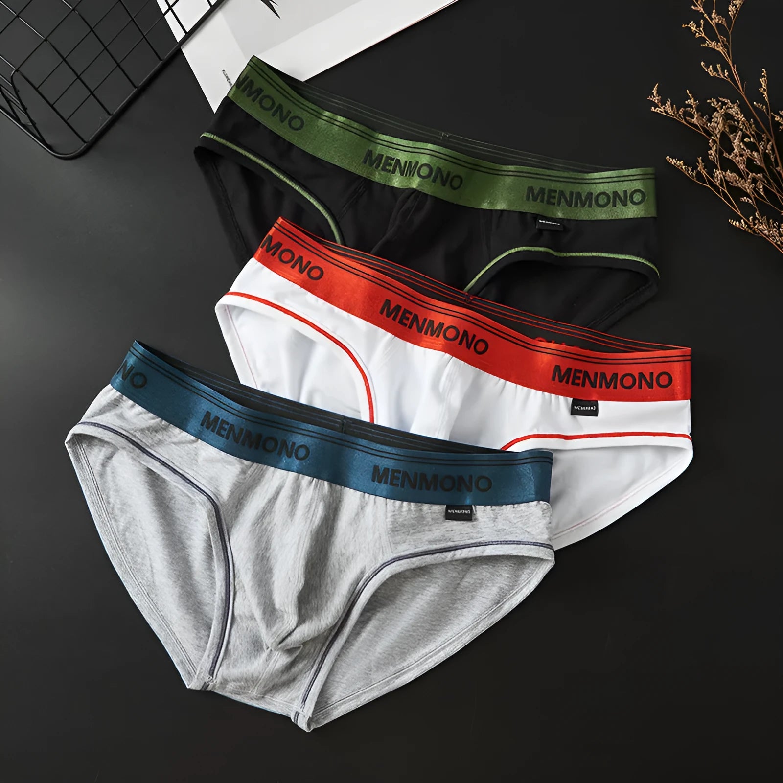 Men's low waist cotton briefs showing solid colour block design in various two-tone combinations.