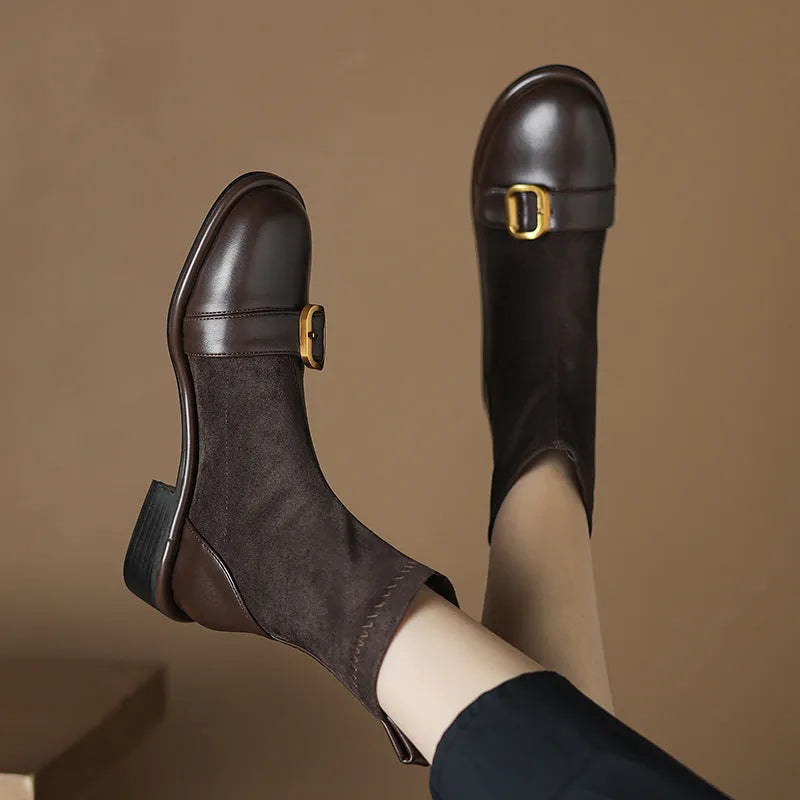 Women's black casual Martin ankle boots with lace-up front and buckle stitching detail on a low heel.