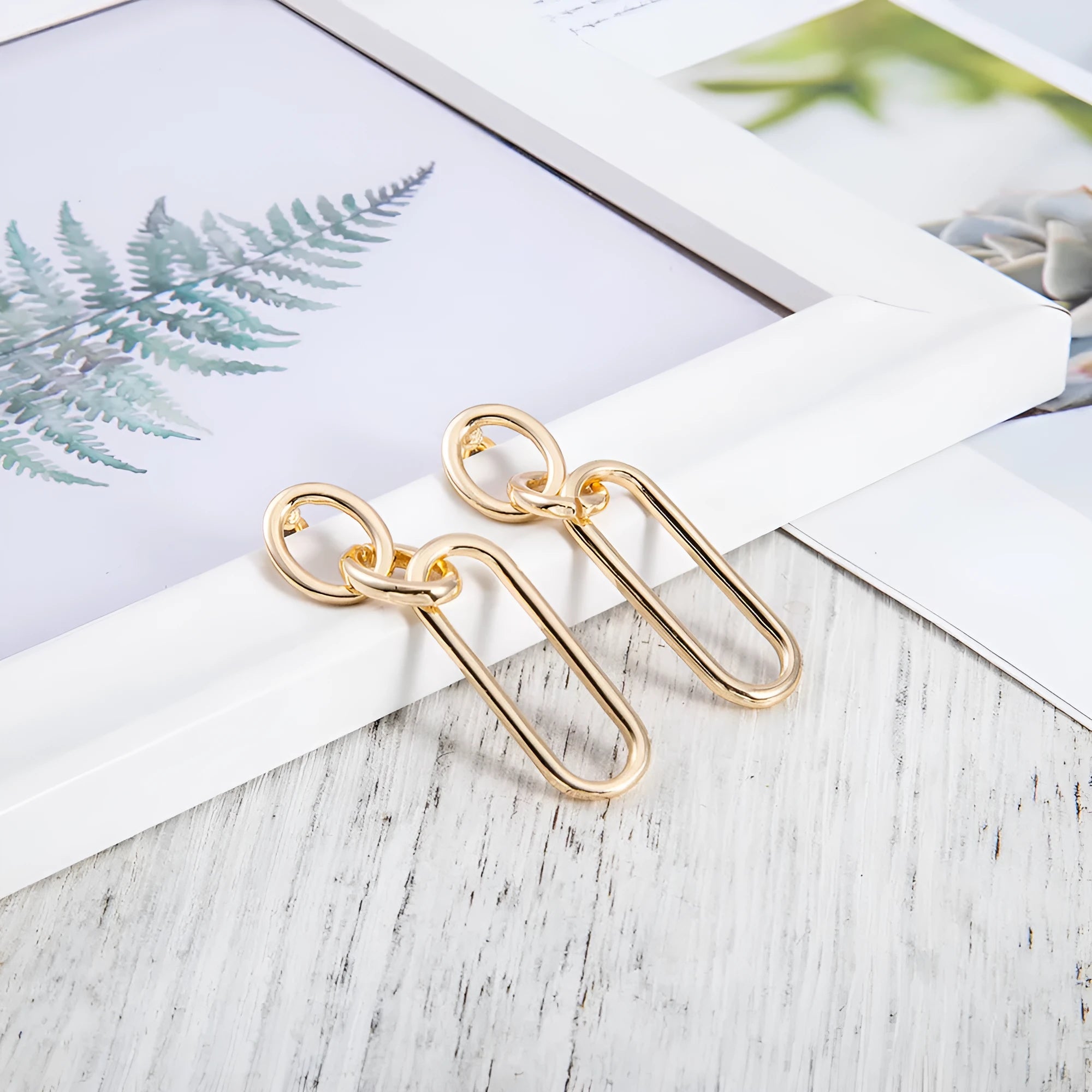 Sterling silver needle coloured geometric hoop earrings for women with ring and line design.