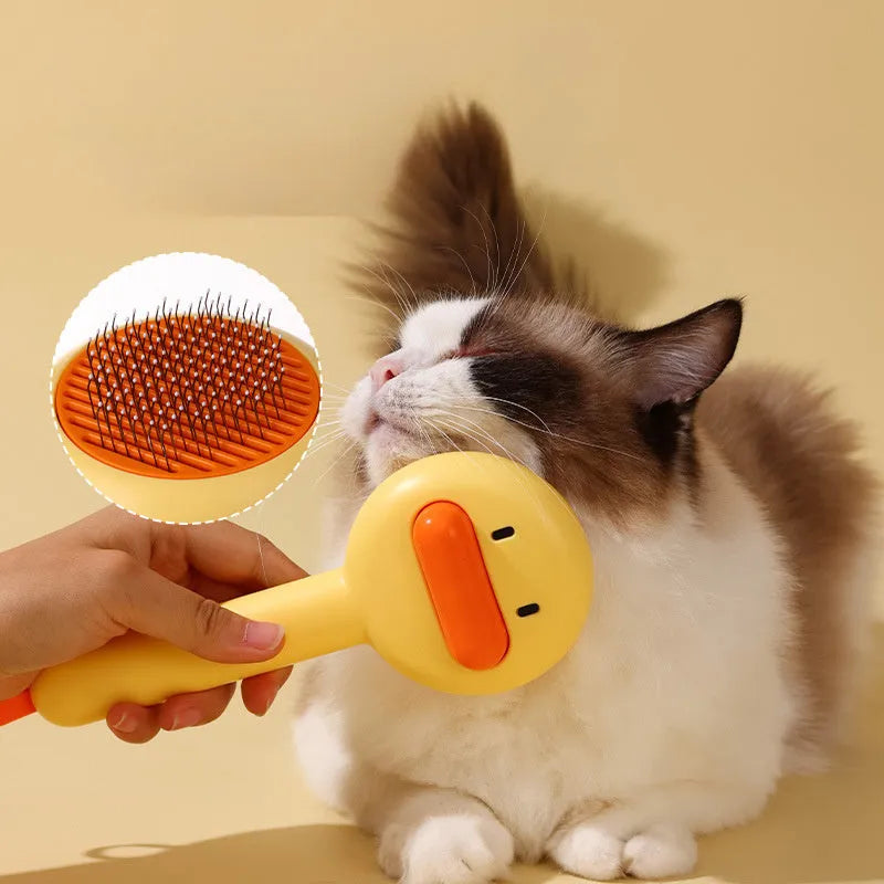 Small yellow duck-shaped pet grooming comb with open section and floating needles