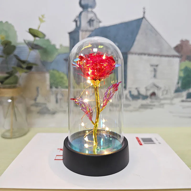 Small plastic night lamp with floral decoration and coloured light options on a black base.