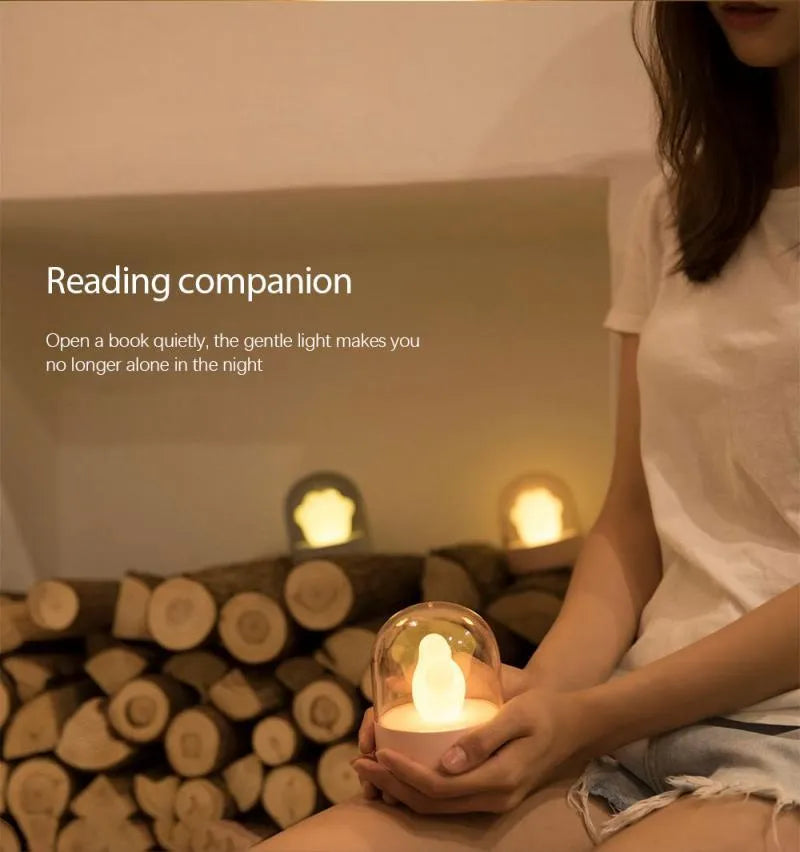 Grey and pink cat paw shaped USB rechargeable night light with adjustable brightness and musical rotation features