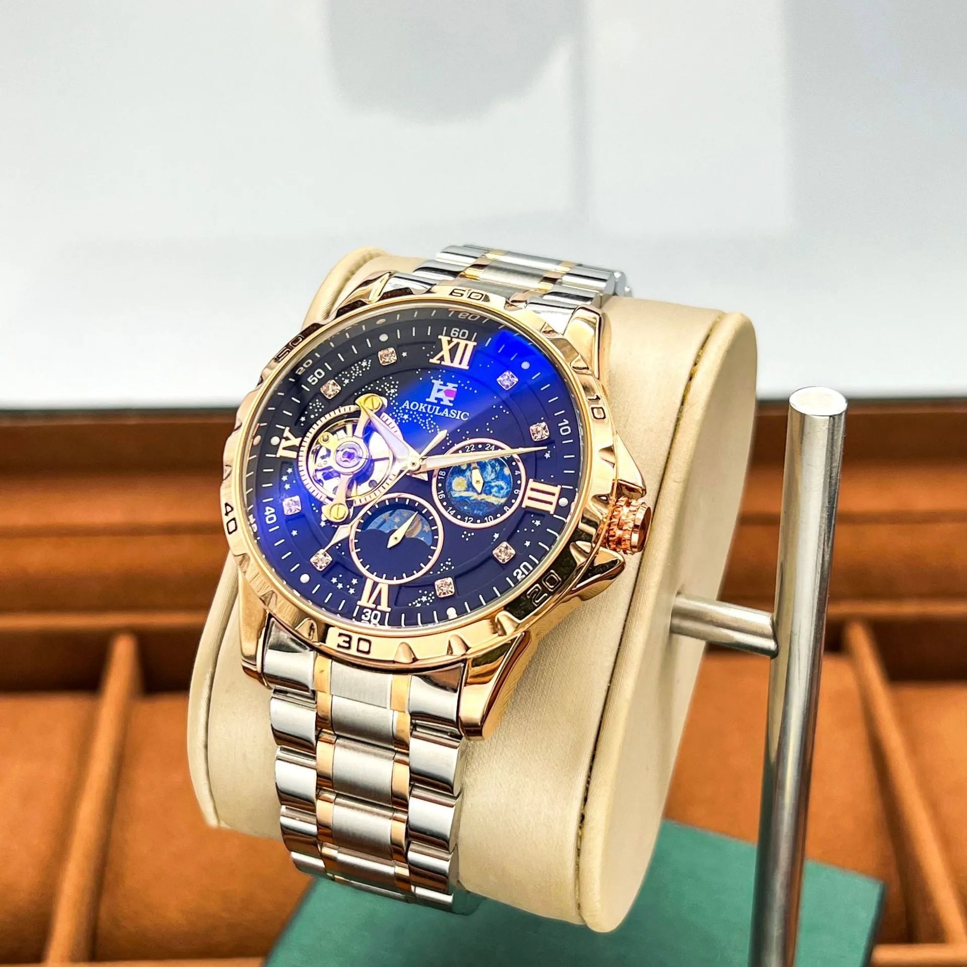 Men's automatic mechanical chronograph watch with rose gold case, black dial, and stainless steel bracelet