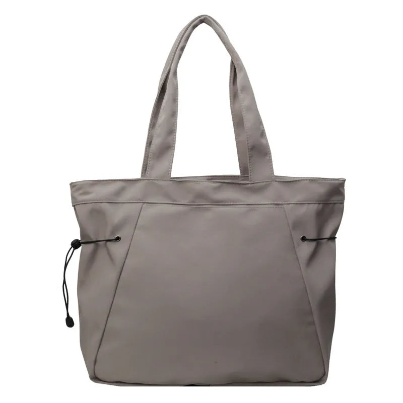 Soft oxford cloth folding commuter tote bag in street style, shown in black, grey, brown, and purple colours.