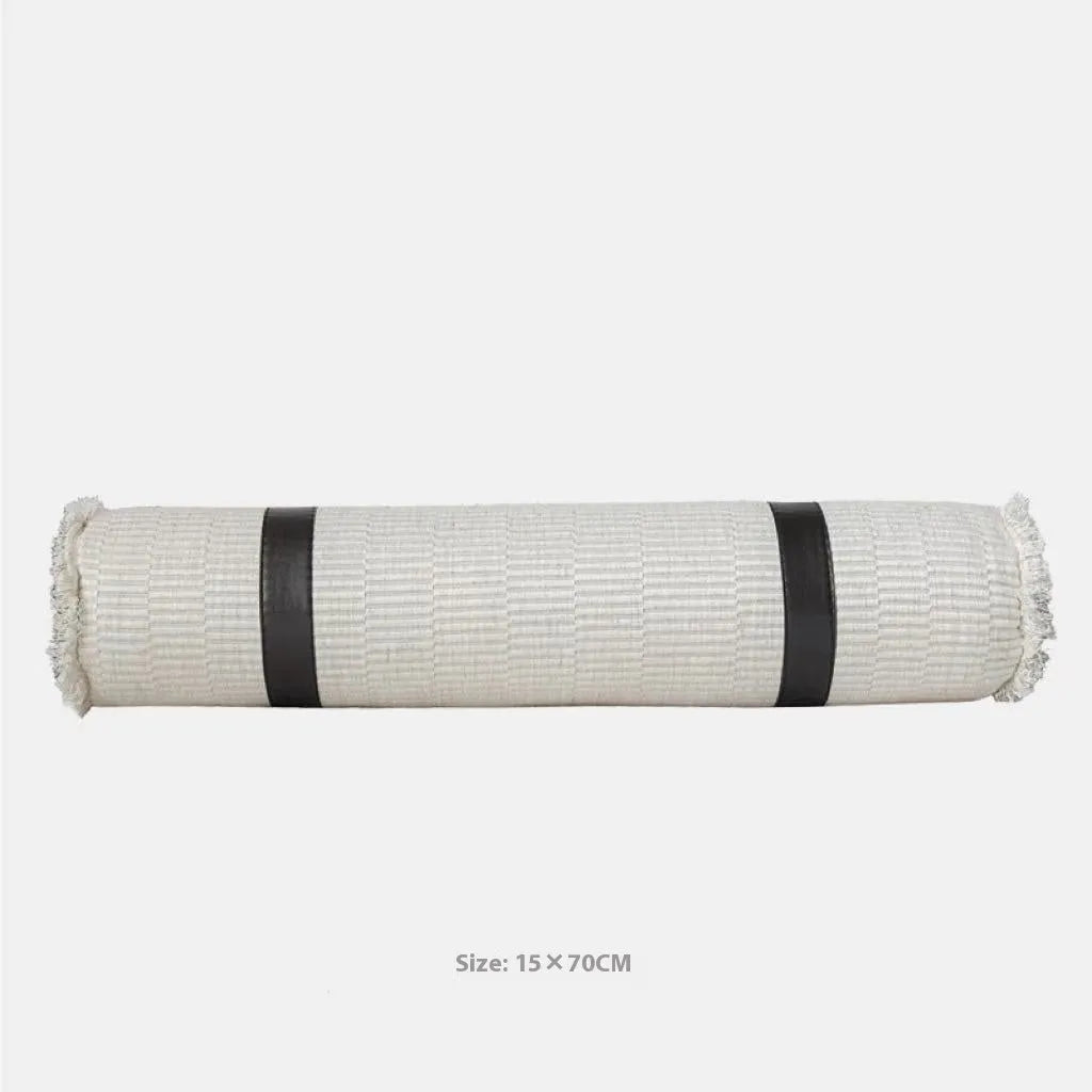 Grey and white plaid polyester bed runner blanket with matching pillowcase and leather round pillow on a double bed.