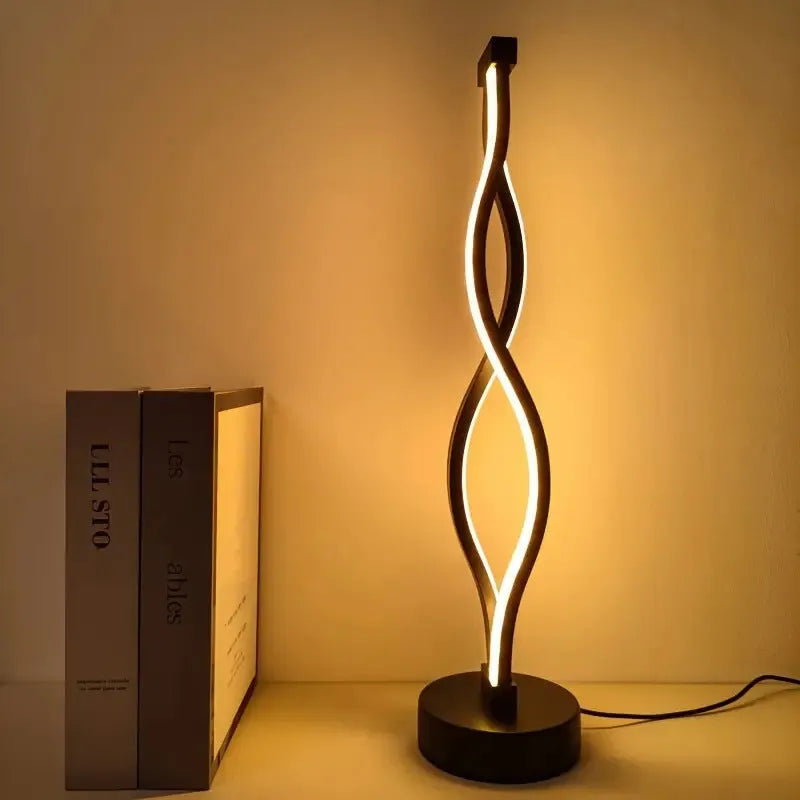 Black aluminium desk lamp with three-colour dimming button and touch controls on desktop