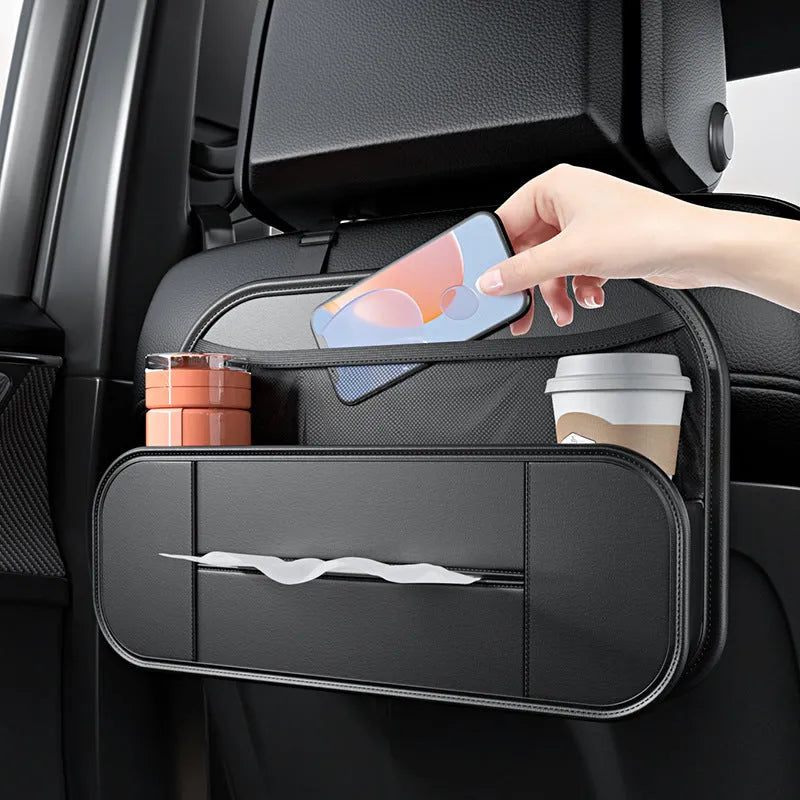 Black leather car seat rear storage bag hanging behind a vehicle seat.