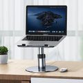 Silver adjustable car laptop stand with height settings and rotating base on a car seat.