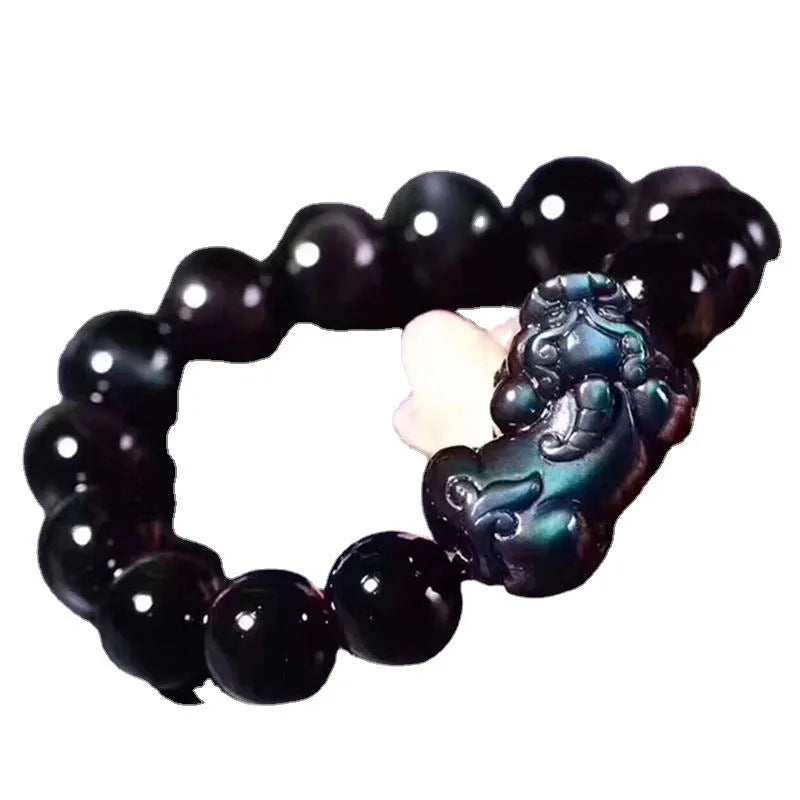 Polished natural ice colour Eye Obsidian crystal beads on an elasticated bracelet cord.