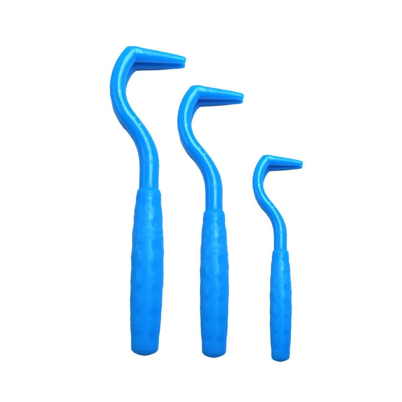 Set of three coloured plastic tick hook removers for dogs on a white background.