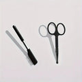 Black dual-sided pet grooming brush with soft bristles for eye area and comb for hair removal