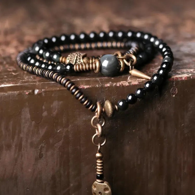 Black geometric beaded bracelet with colourful layered retro design.