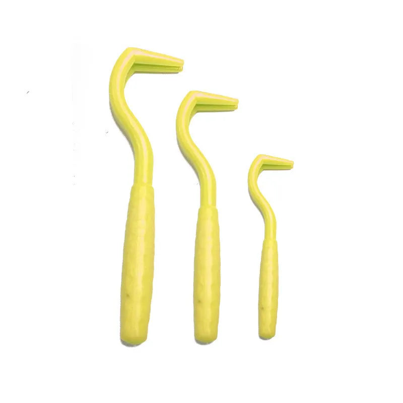Set of three coloured plastic tick hook removers for dogs on a white background.