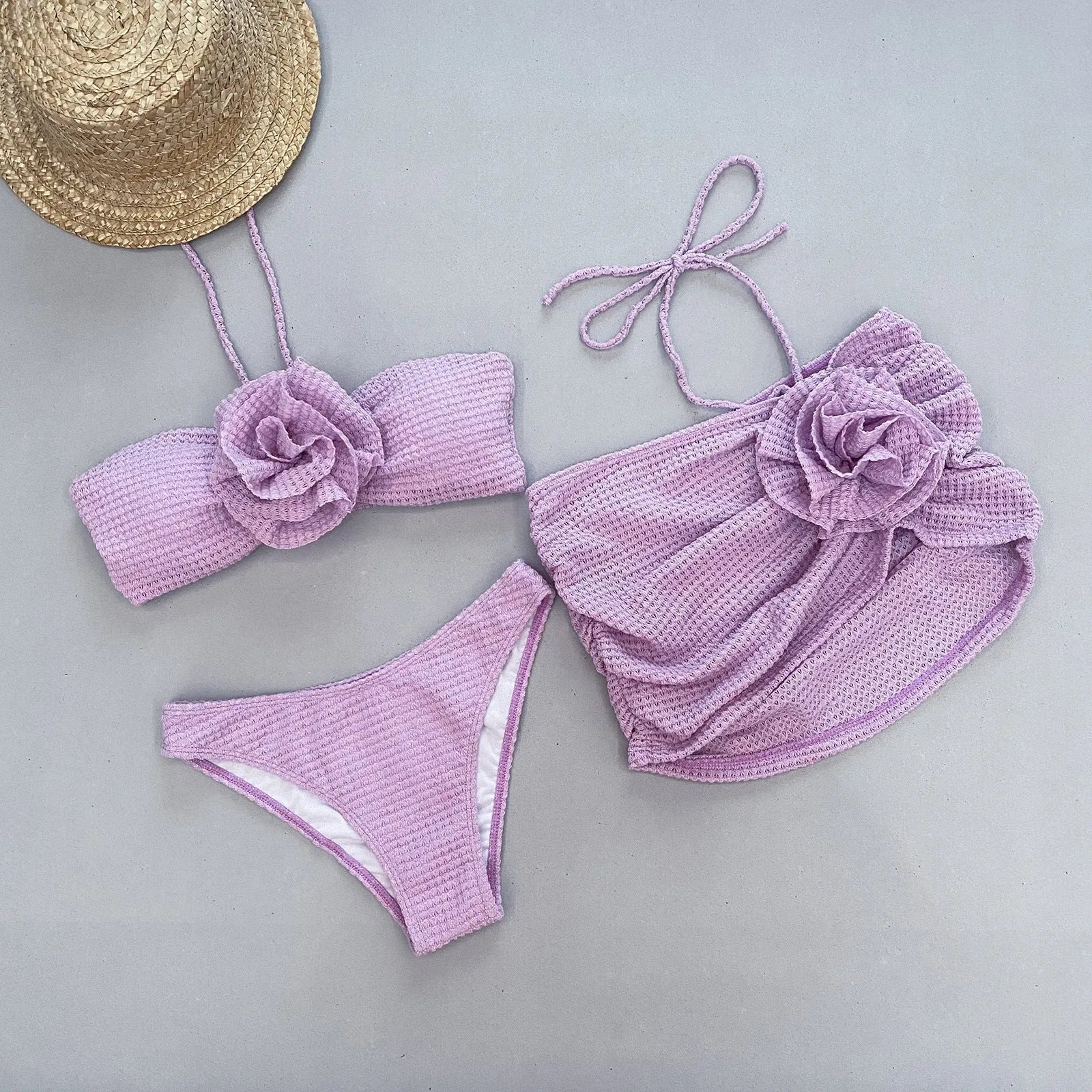 Women's white 3D flower split bikini set with bra, skirt, and briefs.