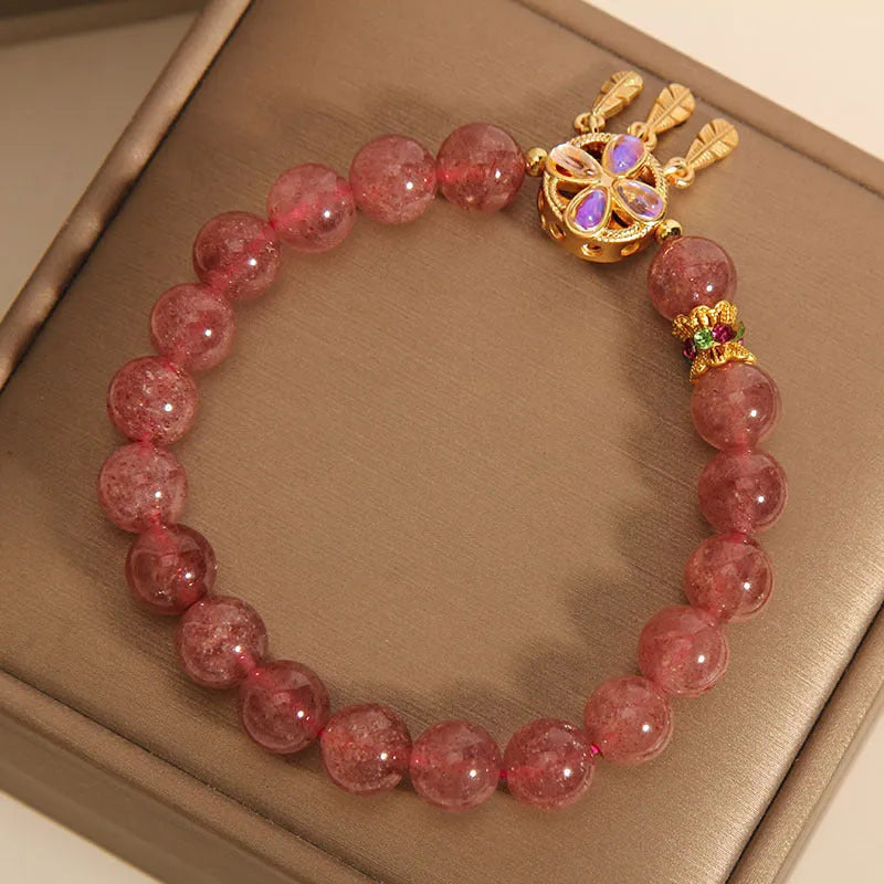 Women's strawberry quartz crystal bracelet with four leaf dream catcher ball pendant in natural rose pink colouration