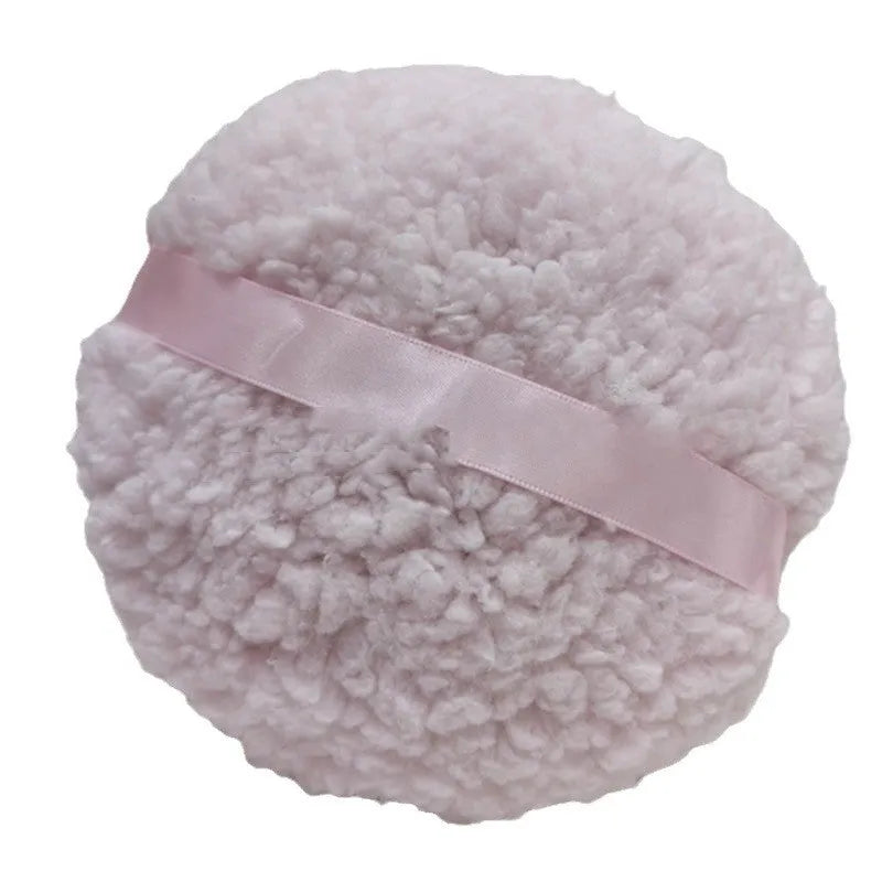 Oversized plush dry powder puff measuring 150x75mm for loose powder application in white skin colour