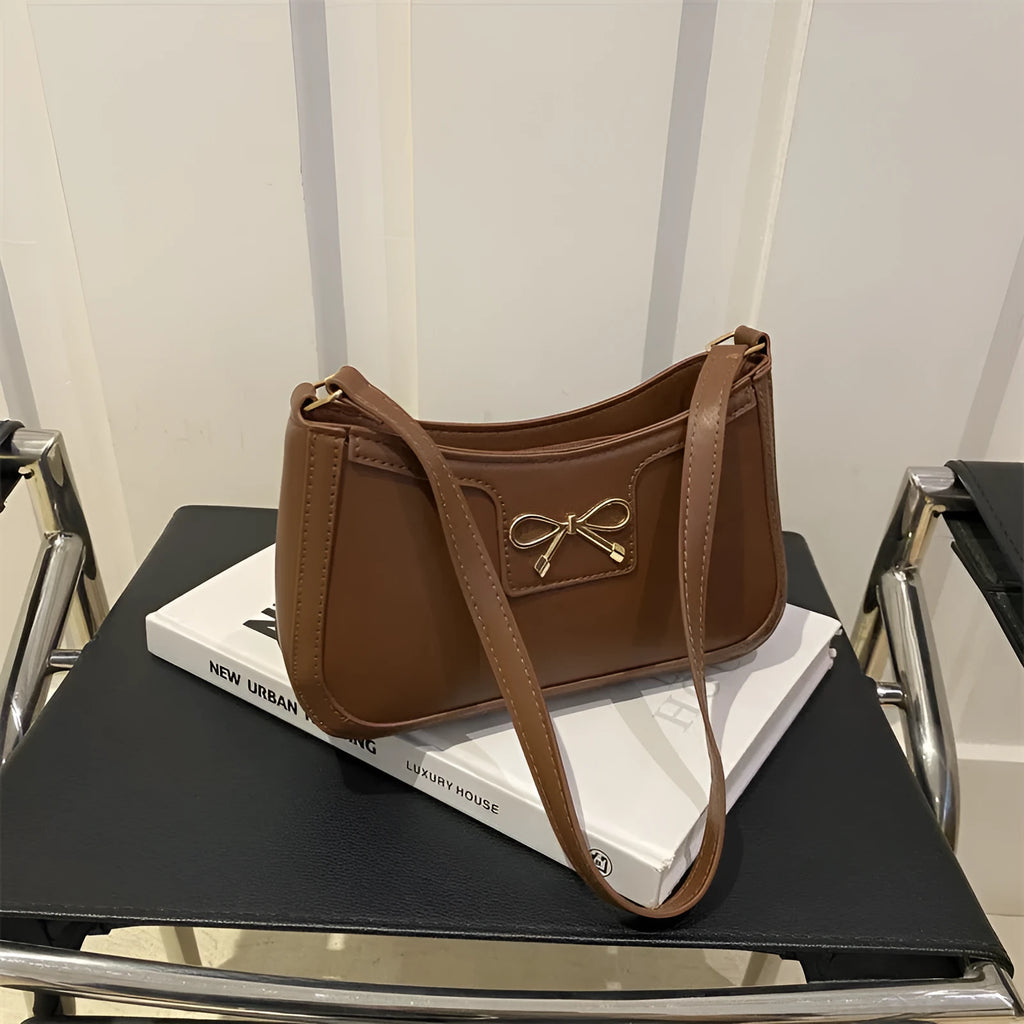Western style PU leather shoulder bag with bow detail in horizontal square shape.