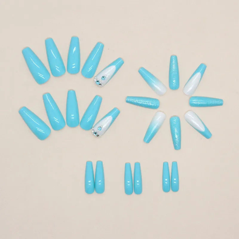 Long ballet shape artificial nails in solid smart blue diamond colour with nail glue bottle.