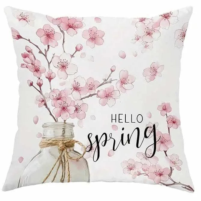 Short velvet square cushion cover with cherry blossom letter print, shown in one of four colour options.