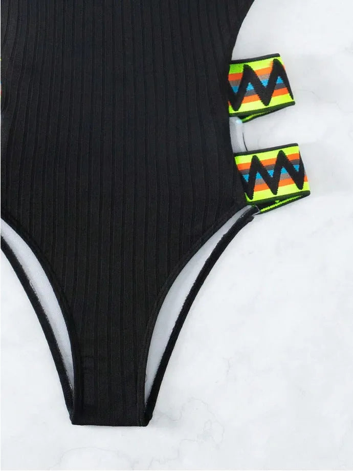 Women's solid colour one-piece bikini swimsuit in black or orange, made from polyester fabric.