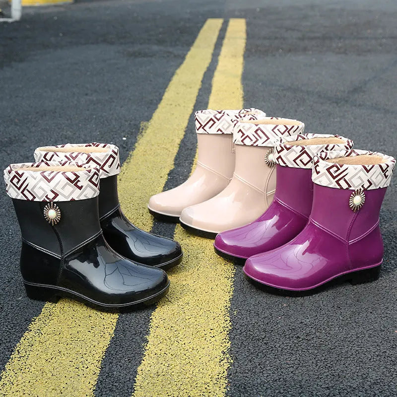 Women's purple rain boot with middle tube height and textured non-slip sole.
