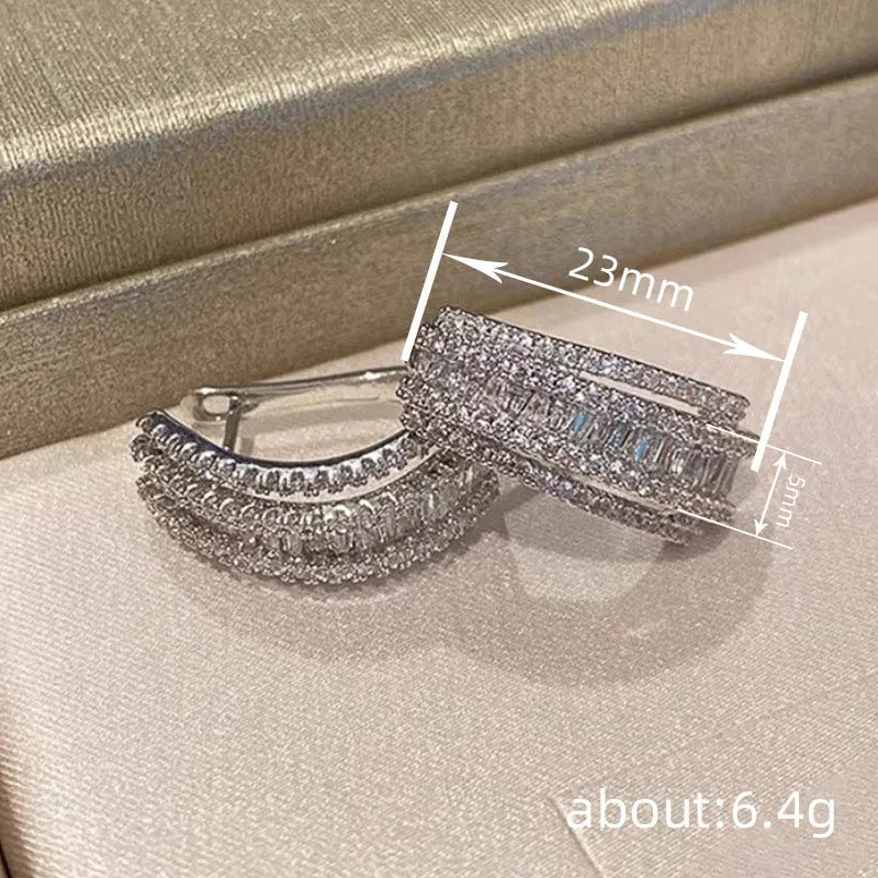 Geometric white gold colour stud earrings with zircon detailing on copper