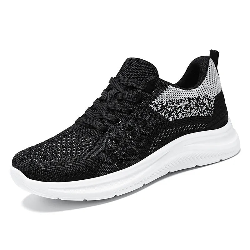 Women's black mesh sneakers with round toe and lace-up design on white background
