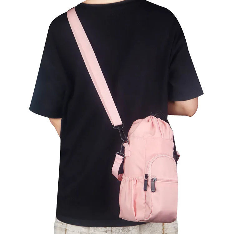 Canvas water bottle shoulder bag with crossbody strap in black, green, and pink colour options