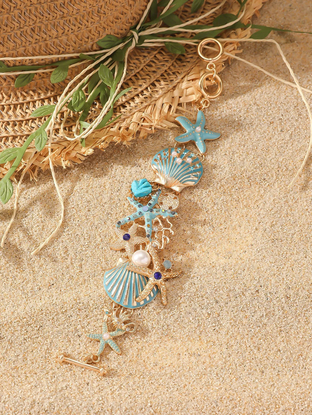 Women's alloy rhinestone bracelet with boat anchor, shell, and starfish charms in blue.