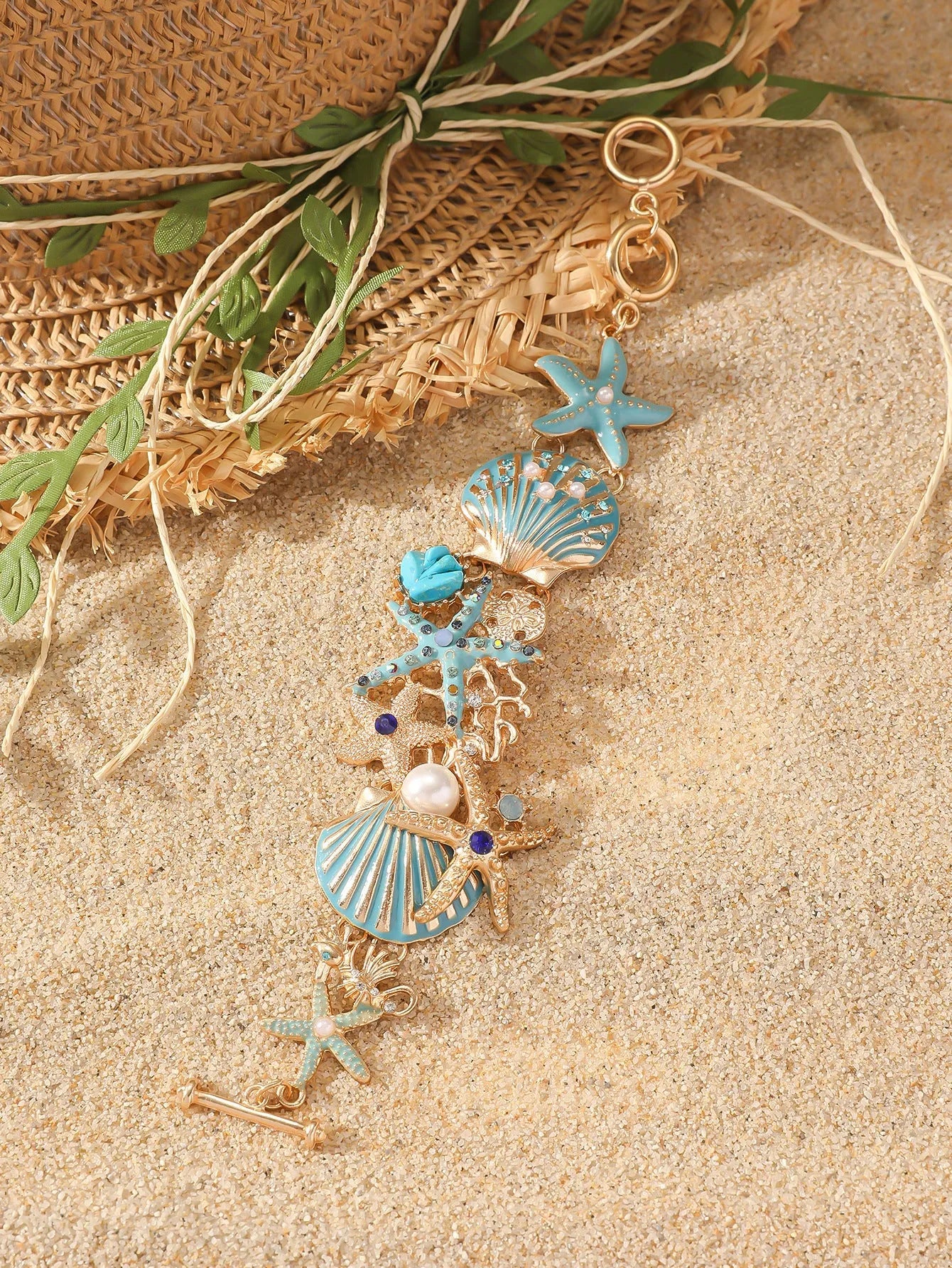 Women's alloy rhinestone bracelet with boat anchor, shell, and starfish charms in blue.