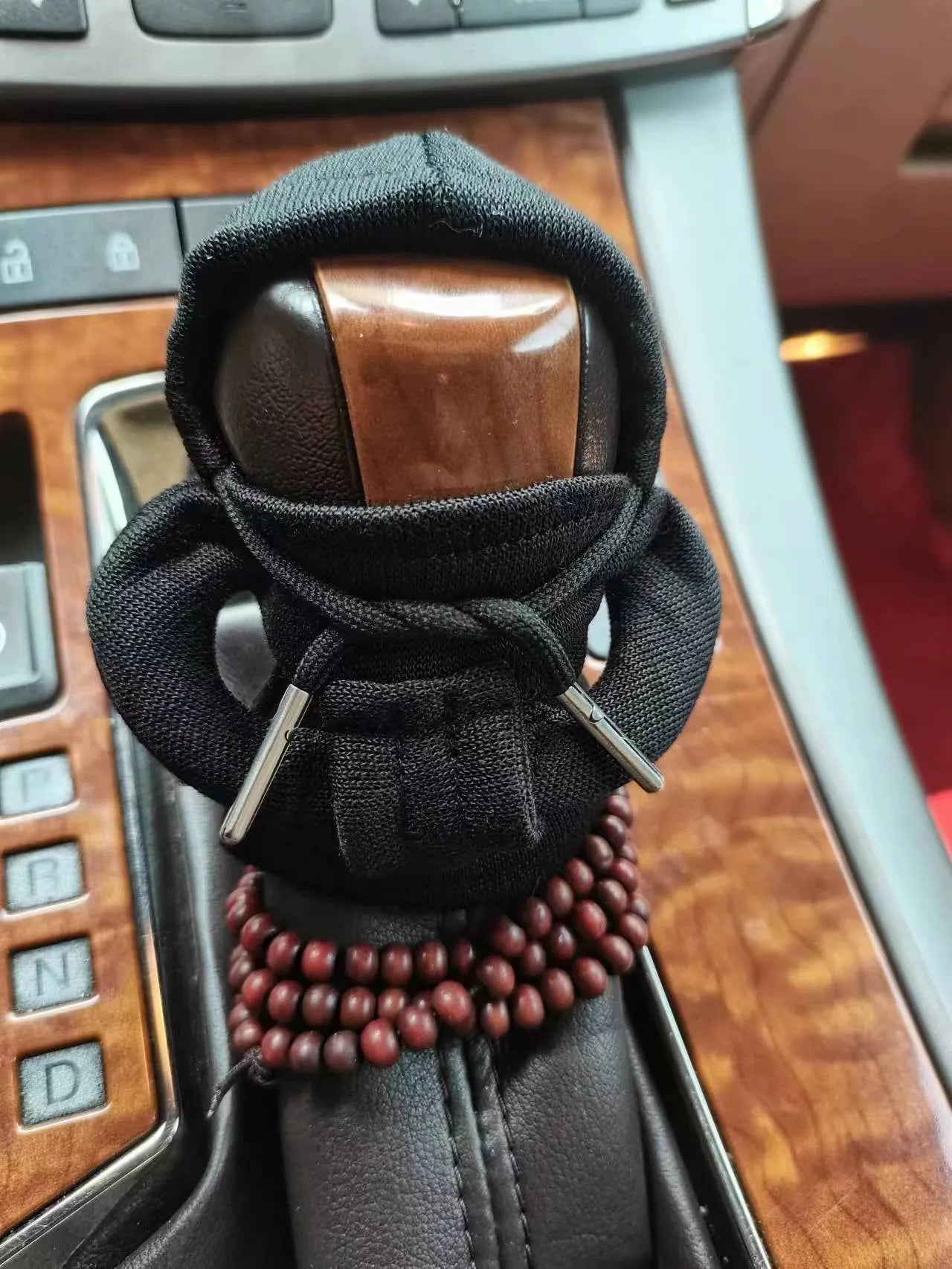 Soft Dutch velvet car gear handle cover in multiple colours on a gear stick.