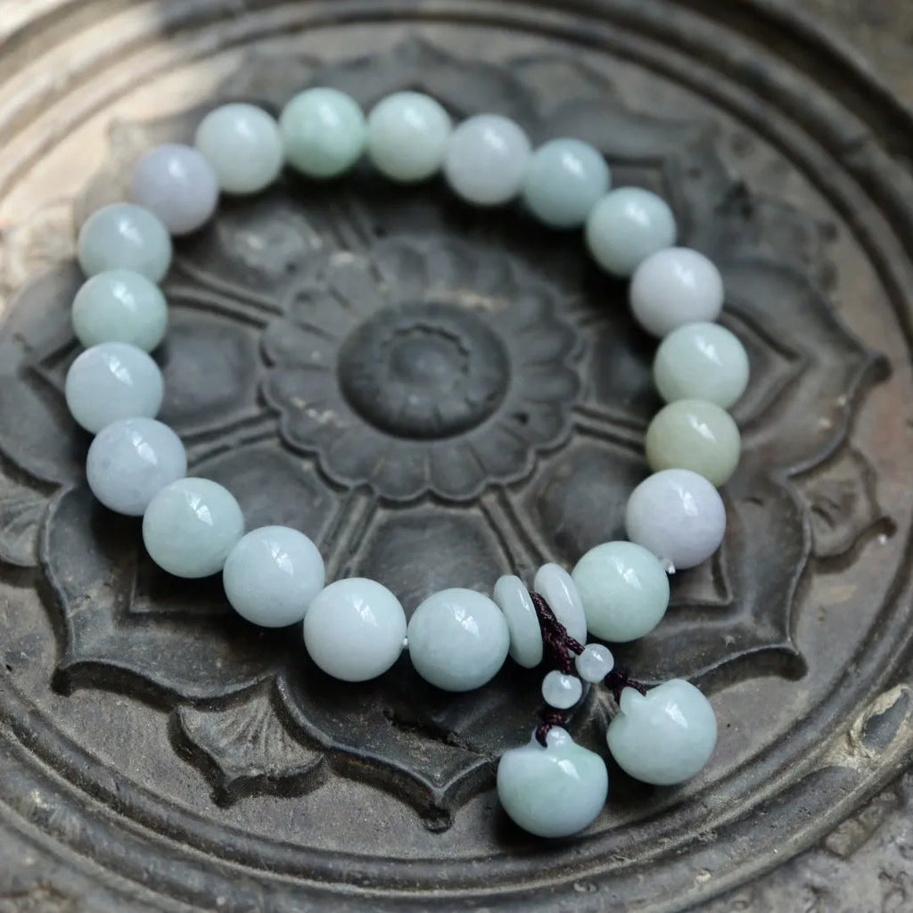 Natural emerald jade geometric bracelet with Maitreya Buddha, apple, and money bag hanging charms.