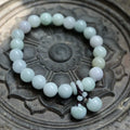 Natural emerald jade geometric bracelet with Maitreya Buddha, apple, and money bag hanging charms.