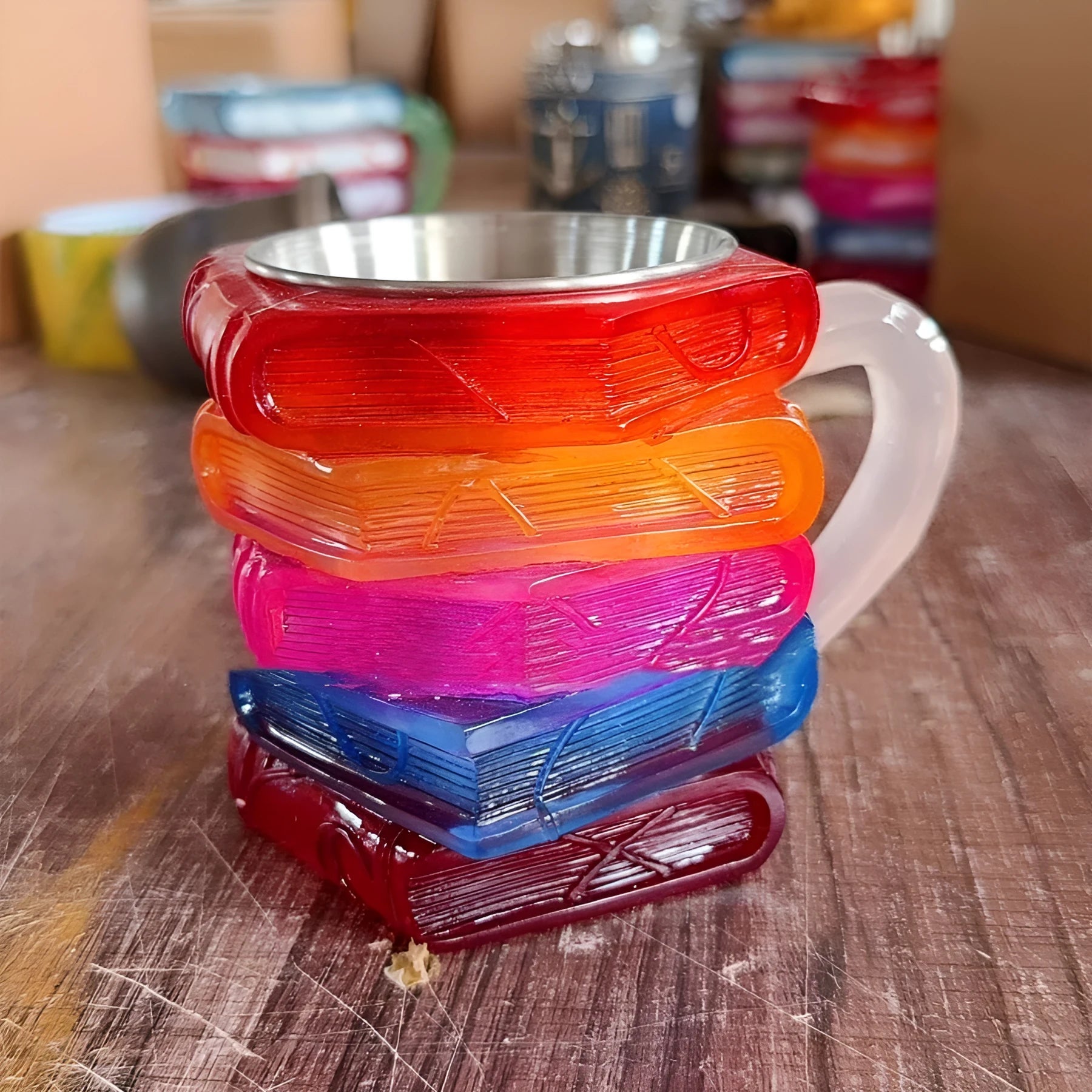 A decorative synthetic resin coffee cup ornament with a painted book design, shown in Library style.