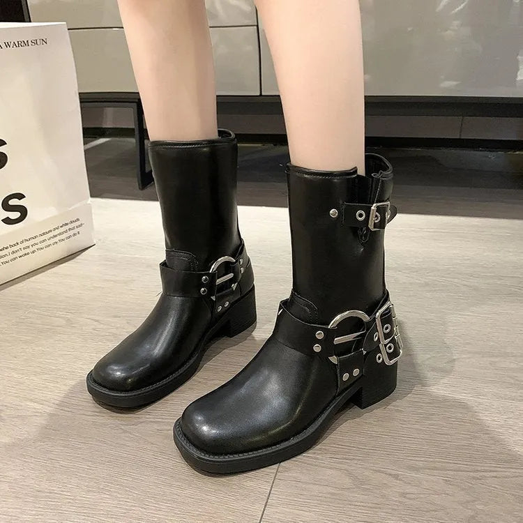 Black women's platform boots with a silver metal buckle strap on the ankle.